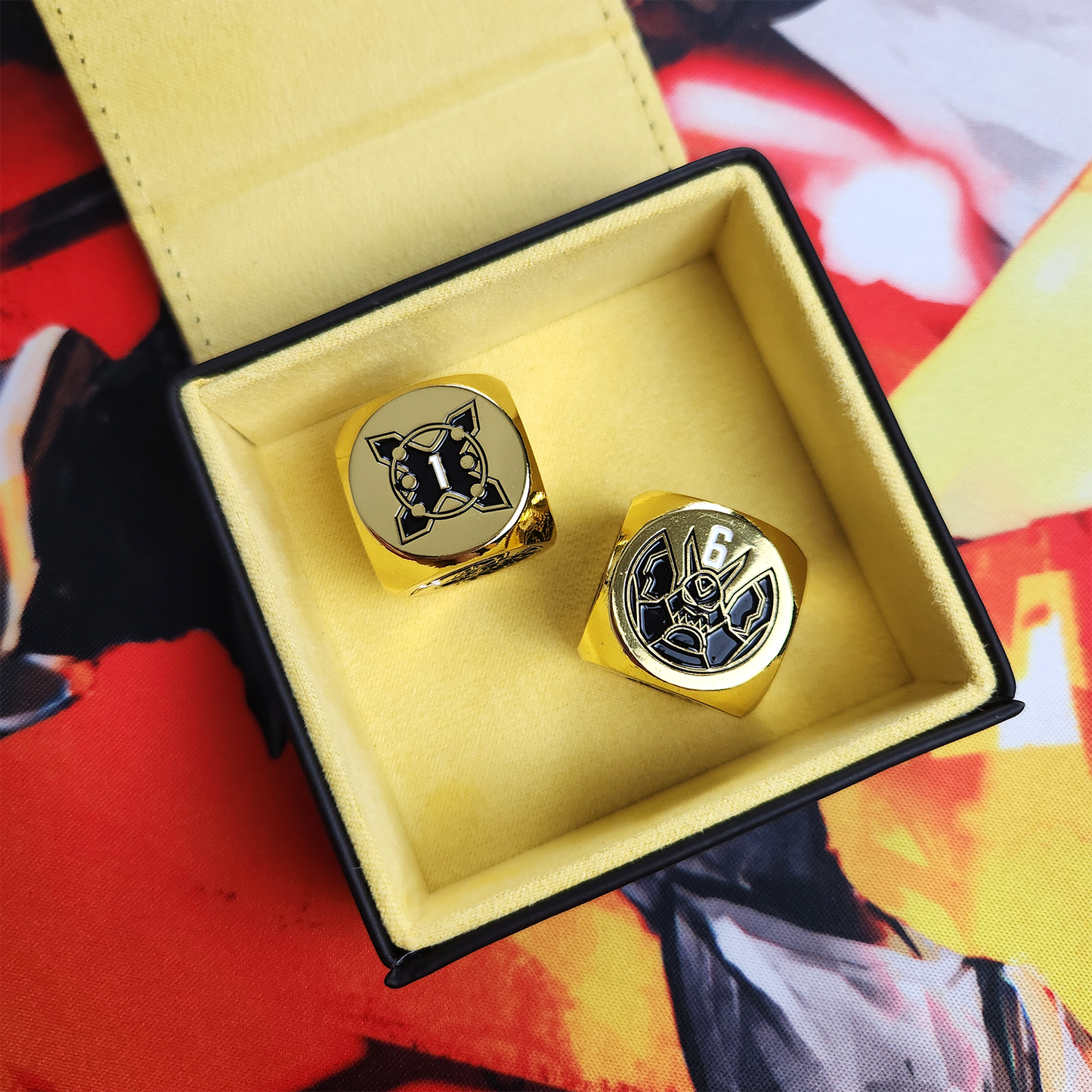 Two gold dice in a dice tray on the Draconic Blade 1-Player Playmat.