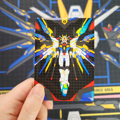 A hand holds a small printed card featuring a colorful robot illustration on a black grid background, with a blurred blue and yellow sci-fi scene behind it.
