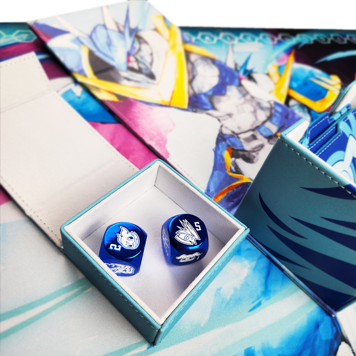 Metallic blue dice, each side featuring a unique character, in the detachable dice tray on top of matching rubber playmat.